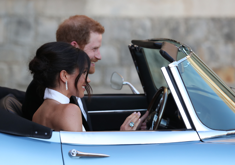 Prince Harry, Duke of Sussex, and his new bride, the Duchess of Sussex, leave Windsor Castle after their wedding to attend an evening reception at Frogmore House, hosted by the Prince of Wales, on May 19, 2018, in Windsor, England.